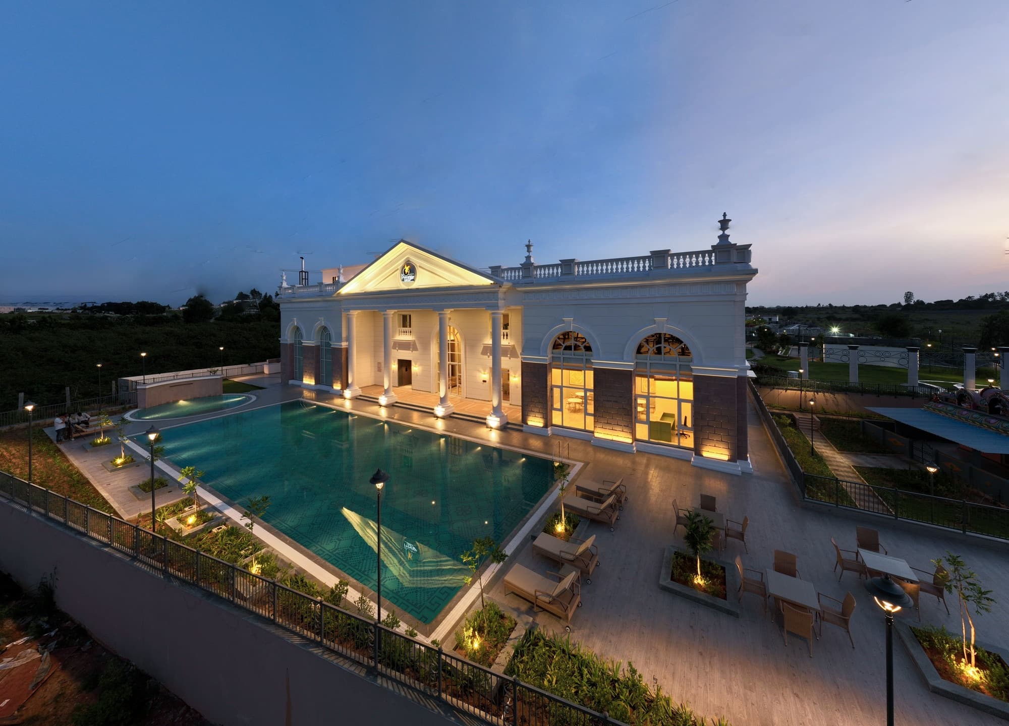 Marigold's pool and clubhouse lit at dusk