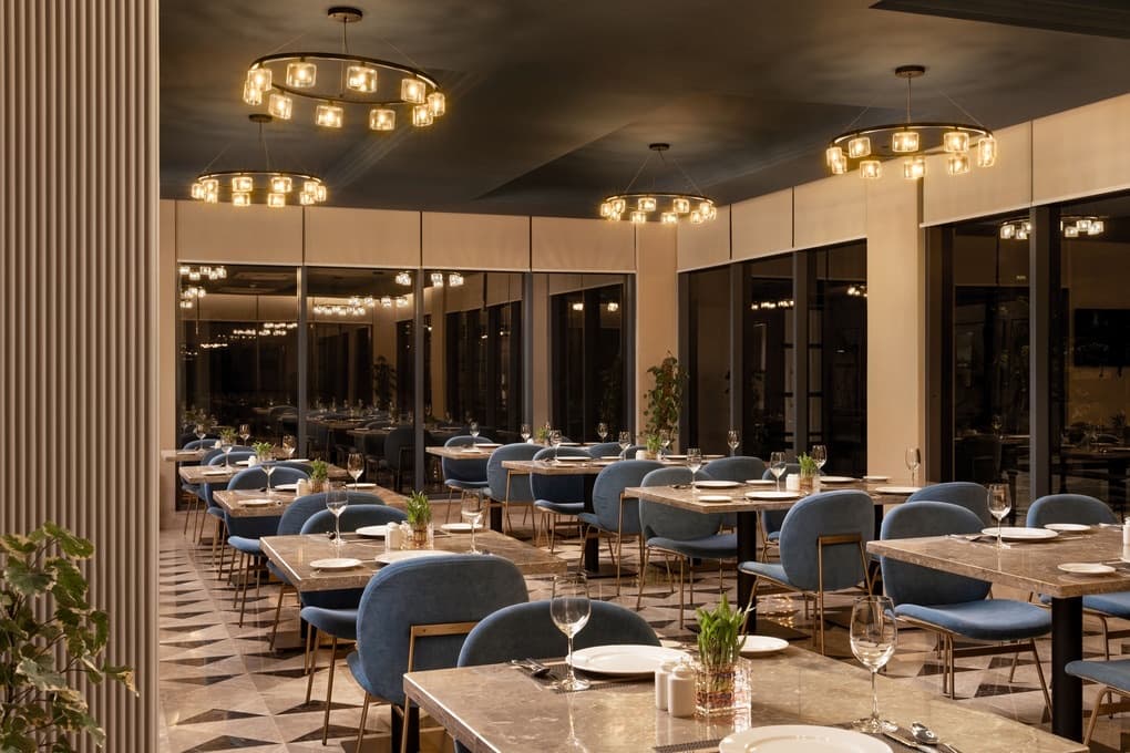 The Falcon Café at Nirvana, set for dinner under chandeliers