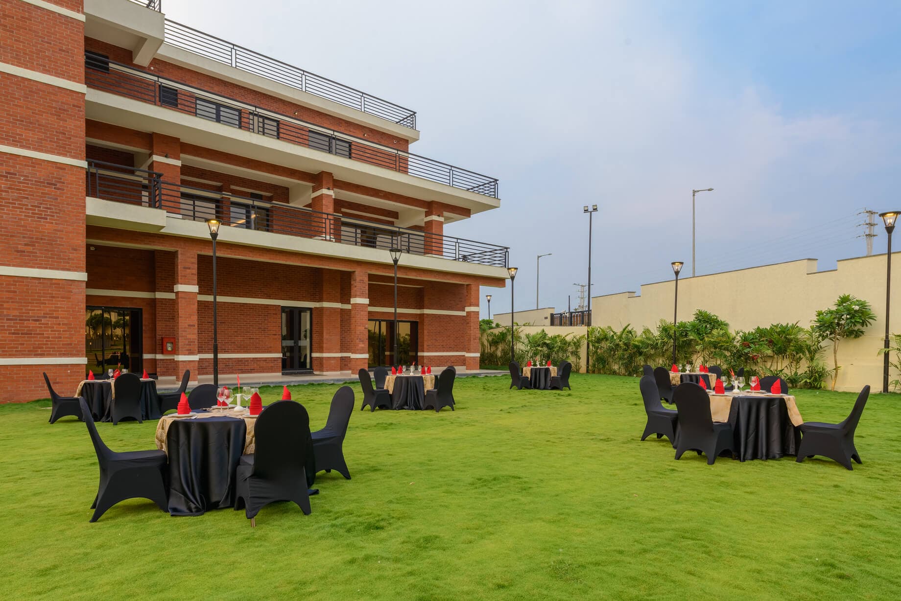 The lawn at Nirvana set with tables, the red-brick clubhouse behind
