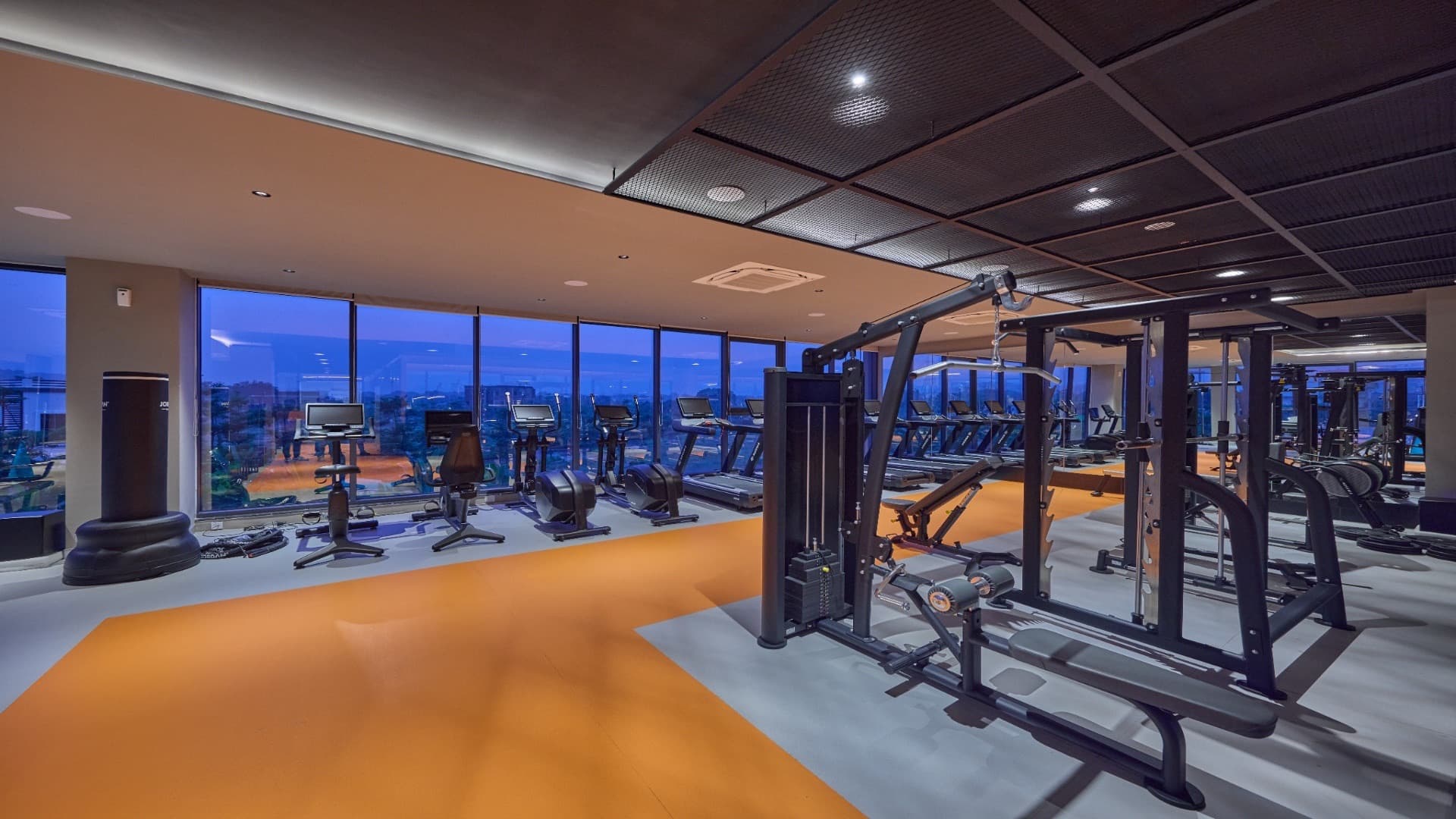 The gym at Orchards, with city views at dusk