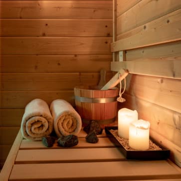 Steam and sauna suite with folded towels and candles