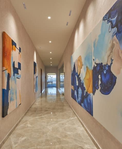An art-lined corridor at Riviera